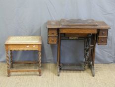 An oak Singer treadle sewing machine and an oak stool