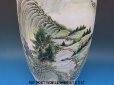 A large Chinese Ching Dynasty vase with Foo Dog handles and landscape decoration,