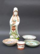 Three Chinese plates two with court scene decoration together with a Chinese figure holding a