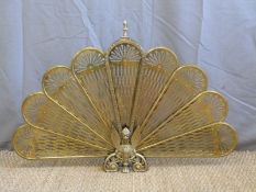 A brass fan shaped fire guard