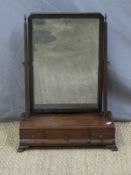 A Georgian mahogany swing frame toilet mirror with three drawers to the shaped base (W43 x H60cm)