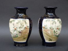 A pair of Japanese Satsuma vases with gilt decoration on dark blue ground, 19cm tall.