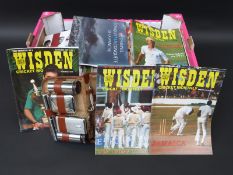 A large collection of cricket related programmes and books