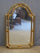 A gilt framed mirror with shaped edge,