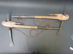 A pair of African ritual or ceremonial tongue and blade axes carved in the form of stylised Ibex or