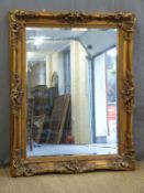 A large gilt framed bevelled edge mirror,