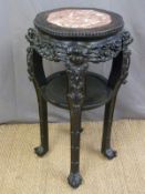 A late 19th/ early 20th century Chinese carved padauk wood marble inset jardinere stand,
