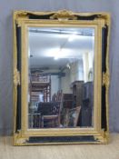 A gilt & black framed mirror with bevelled edge,