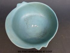 An early Chinese style blue glazed dish of simple design with five stand marks to base,