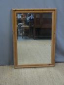 A pine framed bevelled glass mirror (H104 x W73cm)