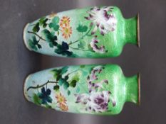 A pair of Japanese Ginbari enamel vases decorated with flames on a graduated green to white ground