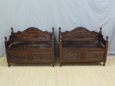 A pair of carved wooden hall seats or benches with hinged seats (W100 x D48 x H80cm)