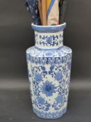 A Chinese blue and white floor vase, 50cm tall, together with various umbrellas, shooting stick,