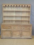 An antique pine dresser base and plate rack,