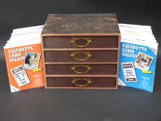 A vintage case containing a quantity of Players and other cigarette cards,