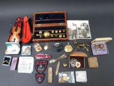 A cased Sikes hydrometer, miniature violin, military Leonidas pocket watch, fobs, penknives,
