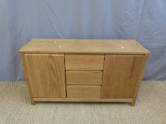 A low pine sideboard with two cabinets either side of three drawers (W122 x D39 x H70cm)