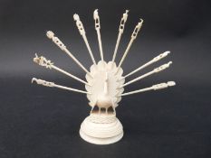An early 20thC carved ivory toothpick holder in the form of peacock,