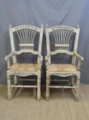 A pair of wicker seated carver chairs with painted decoration