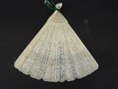 A 19th/20thC carved ivory brise fan, the guard sticks carved with figures and dragons,