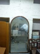 A very large oak framed arch topped mirror,