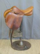 A leather saddle bar stool on industrial steel base