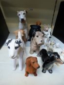 A collection of ceramic dogs to include Sylvac, Crown Devon etc.