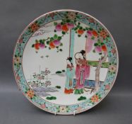 A Chinese charger decorated with two geishas under a peach tree,