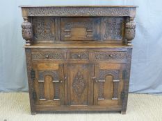 An oak court cupboard with single cupboard to top,