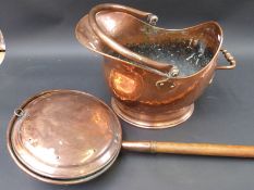 A hammered copper coal scuttle and a copper warming pan