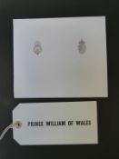 A scrap book containing a luggage tag 'Prince William of Wales',