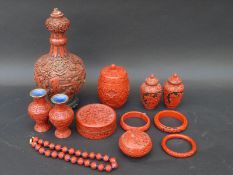 A quantity of faux cinnabar lacquer items including pots, necklace, vase, etc.