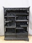 A Japanese heavily carved black lacquer bookcase/shelf unit with two drawers to base (H98 x W72 x
