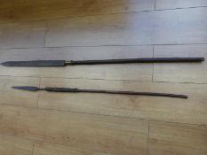 Two tribal spears one with engraved 56cm blade and metal fittings, 135cm long,