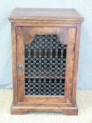 An Eastern hardwood cabinet with metal grille front (W60 x D48 x H91cm)