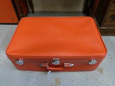 A vintage Emelia Earheart red suitcase,