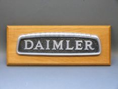 An aluminium Daimler badge, ex double decker,
