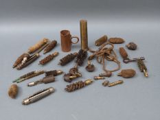 A collection of gun cleaning kit including pull-throughs, brushes, nipple key, brass bottle etc.