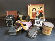 A group of collectables including Meerschaum pipe, cameras, cigarette lighter, chamber stick,