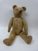 An English straw filled blonde mohair teddy bear with hump back,