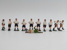 A set of 11 lead model football players in white and blue kit.