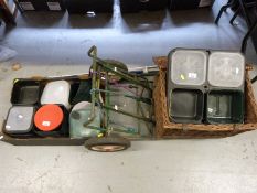 A wicker fishing basket, trolley, large quantity of bait boxes and swim feeders,