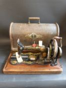 A c1860 Singer portable sewing machine in wooden case