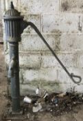 A cast iron water pump with reeded top section.