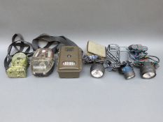 Three camouflage trail/wildlife cameras together with three head torches
