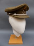 Three European military peaked hats and a police hat