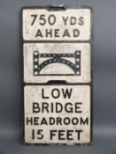 A vintage cast aluminium '750 yards ahead low bridge headroom 15 feet' road sign with bullseye