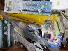 A collection of fishing accessories including unopened scissors / tweezers, light sticks,