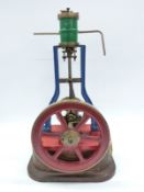 Live steam vertical 'A' frame steam engine mounted on wooden base with spoked drive pulley,