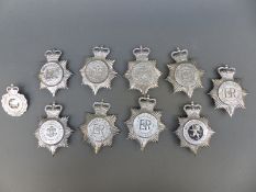 Ten police helmet badges including Devon Constabulary, Humberside, South Yorkshire, Denbighshire,
